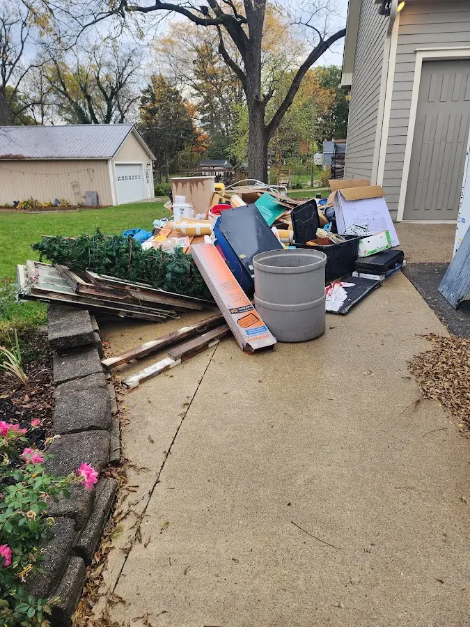 Dumpster being loaded with debris for Estate Cleanout Dumpster Rental in New Milford